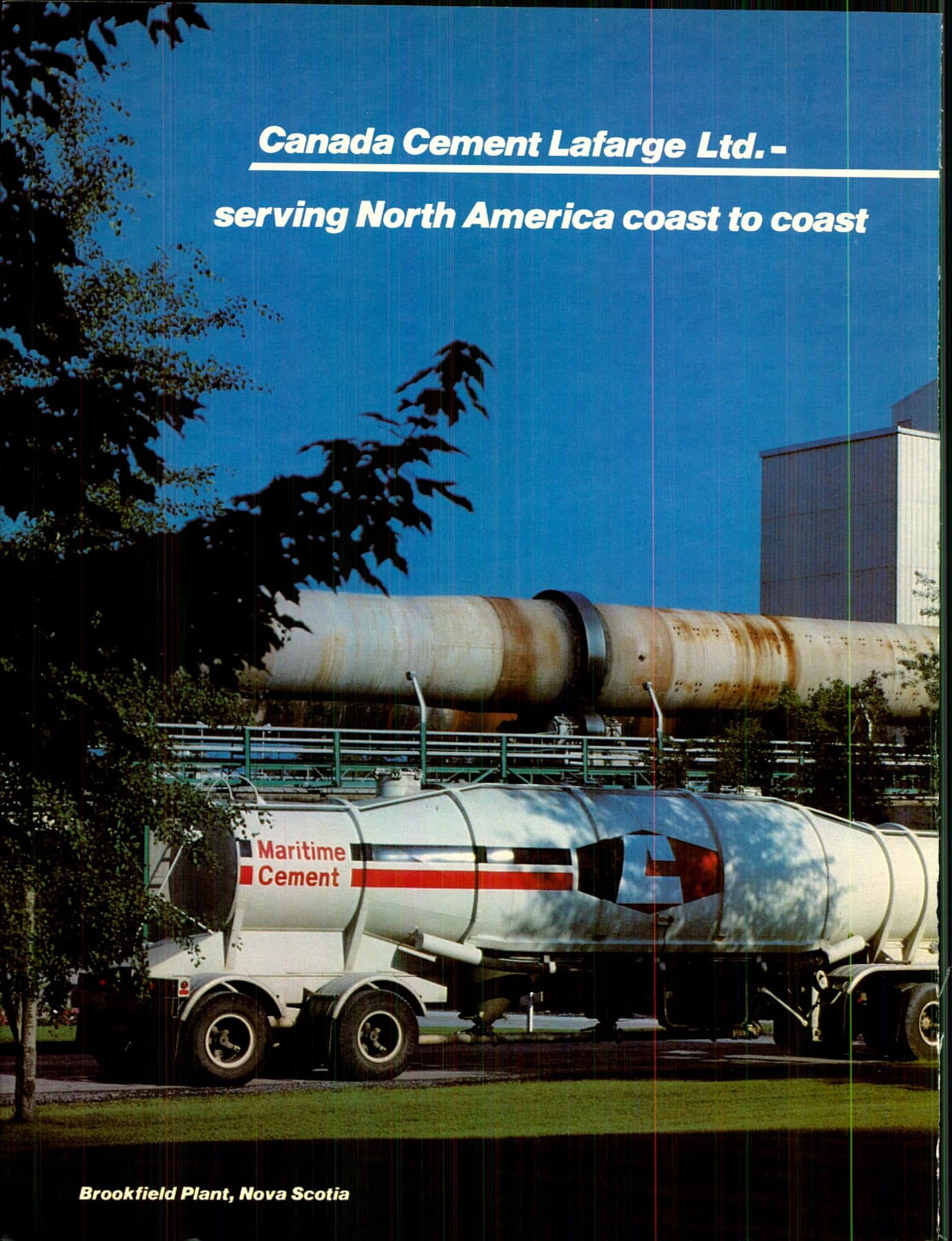 A Maritime Cement bulk tank truck at the Brookfield, Nova Scotia plant, a kiln tube behind it.
