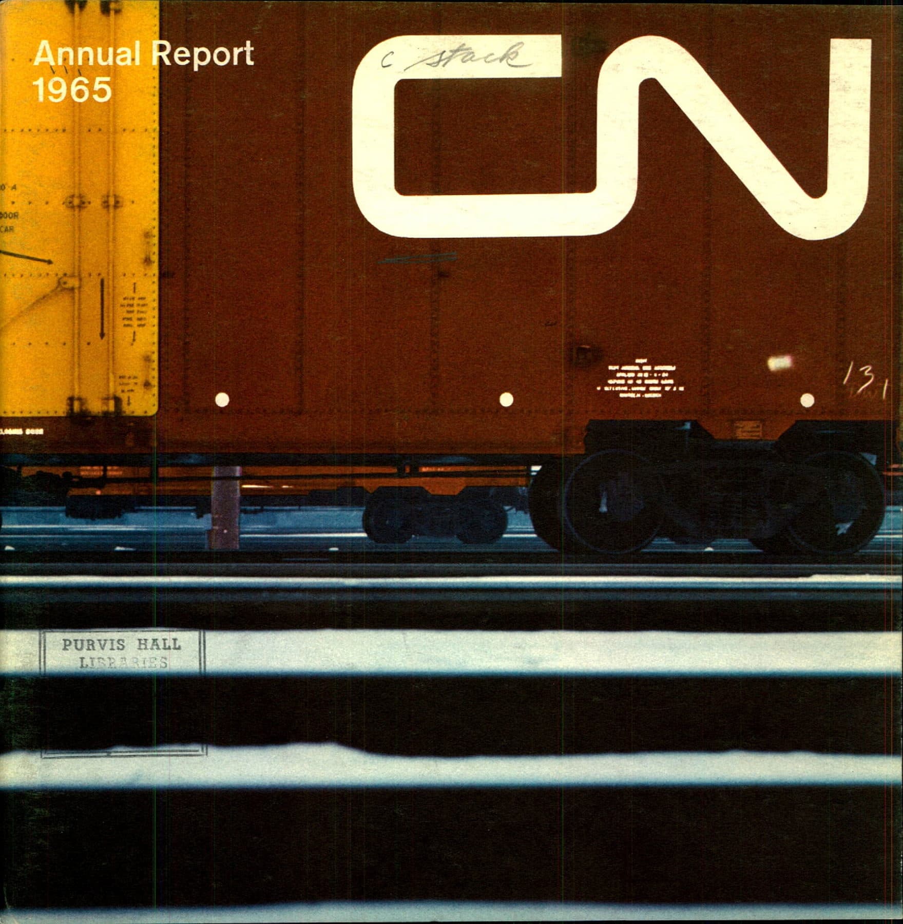 A brown CN boxcar with the white worm logo, shot low across the tracks.