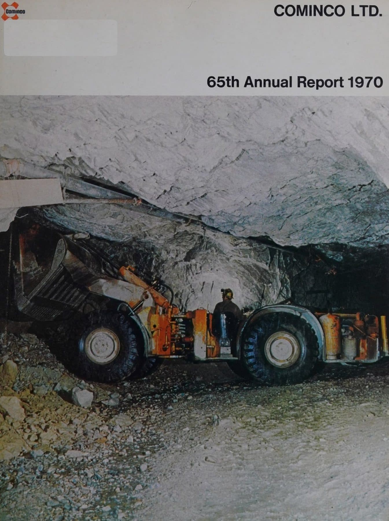 Underground LHD loader at the face, miner in the cab.