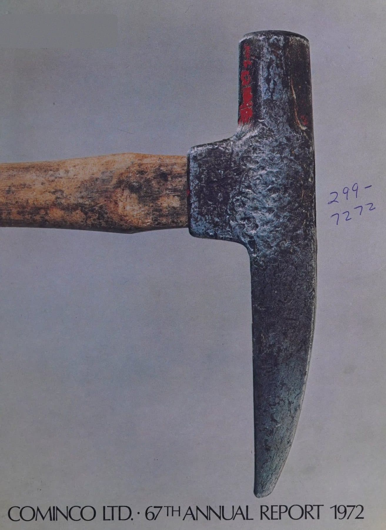 A worn pickaxe head, close as a still life.