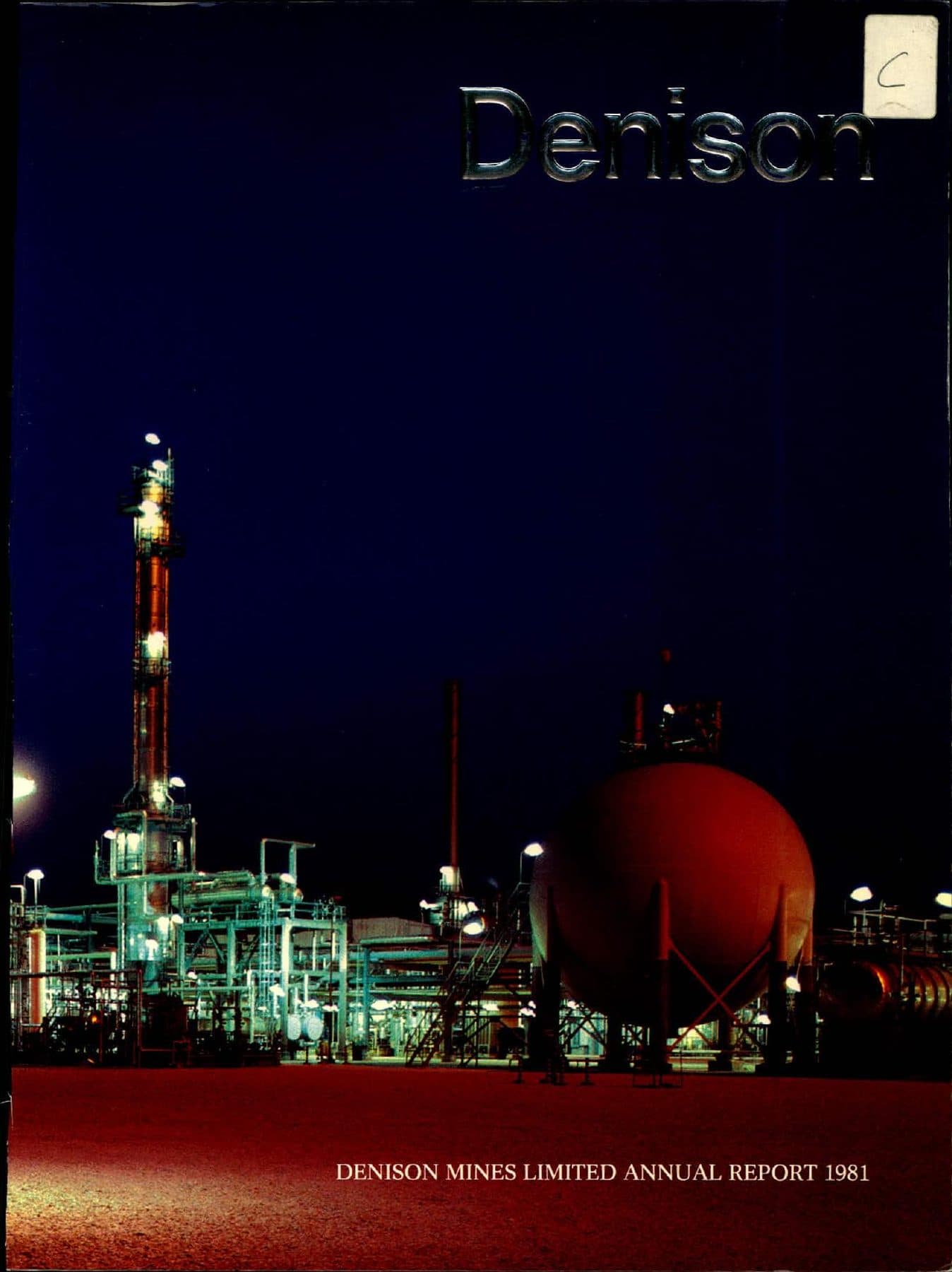 Process plant at night: tower, red tank, deep blue sky.