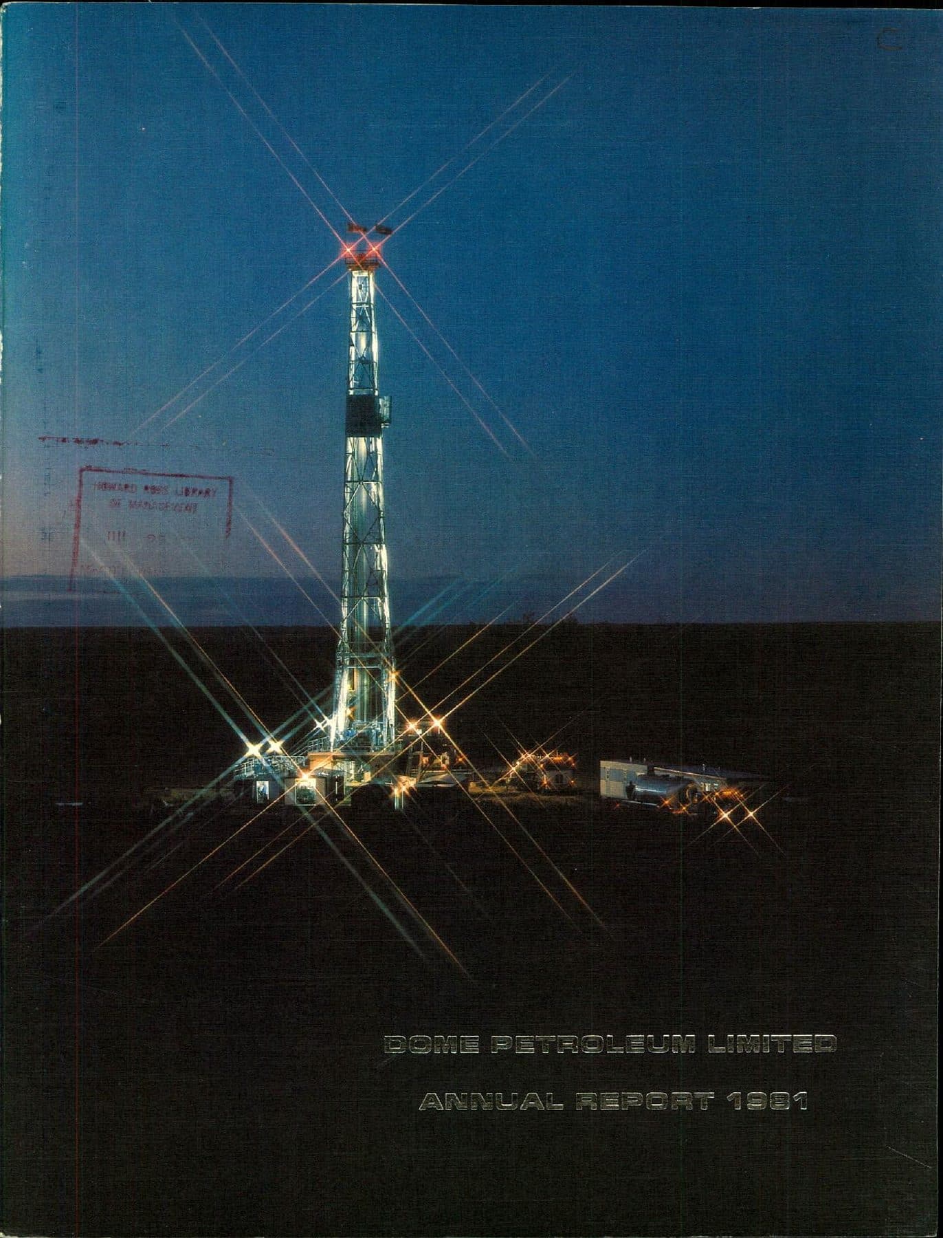 Prairie drill rig lit like a star at dusk.